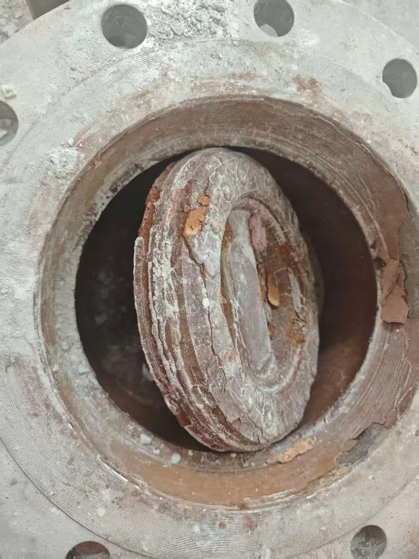 Worn metal valve parts after corrosive ore slurry service