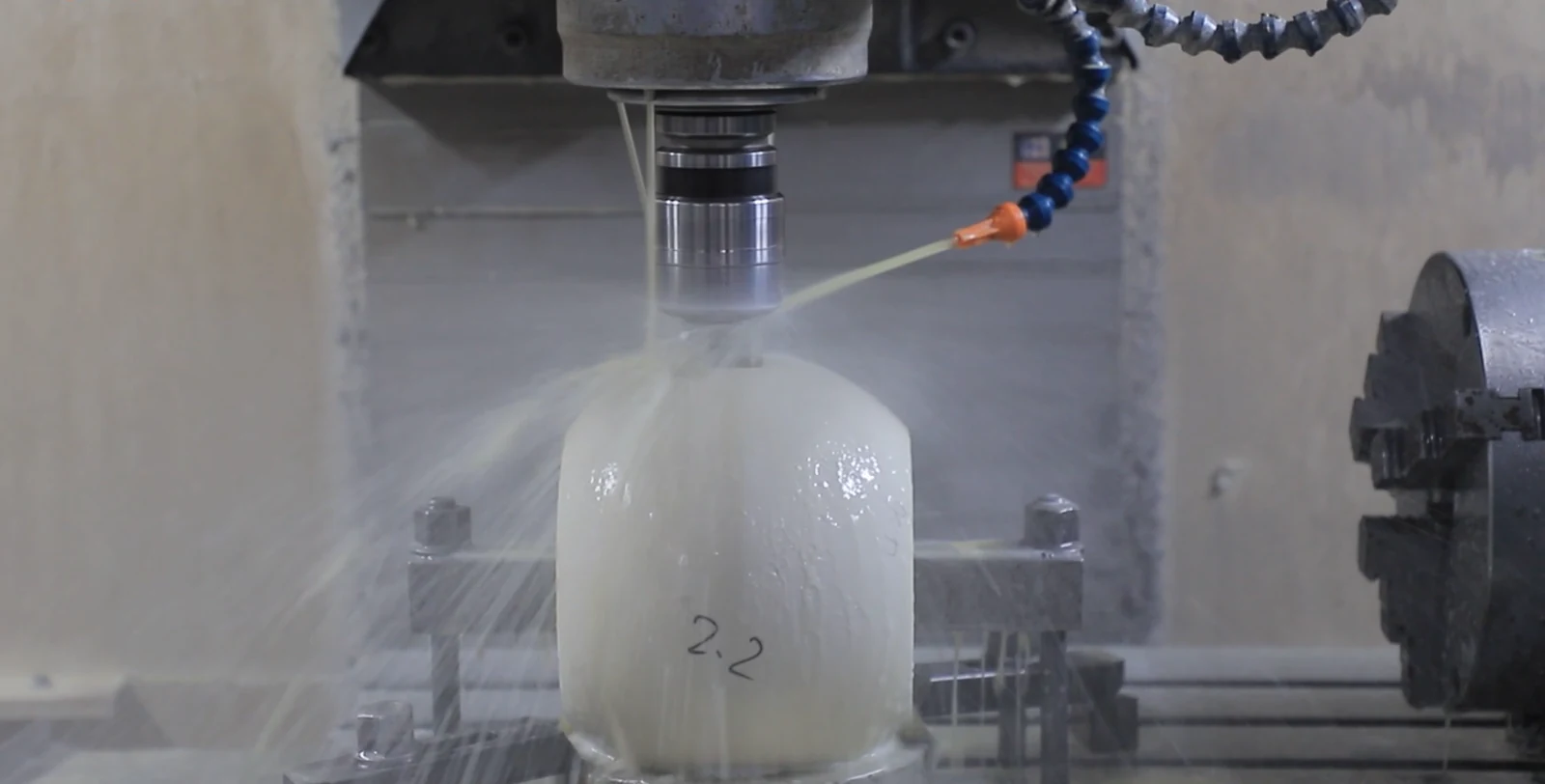 Ceramic ball being precision-machined at the current factory