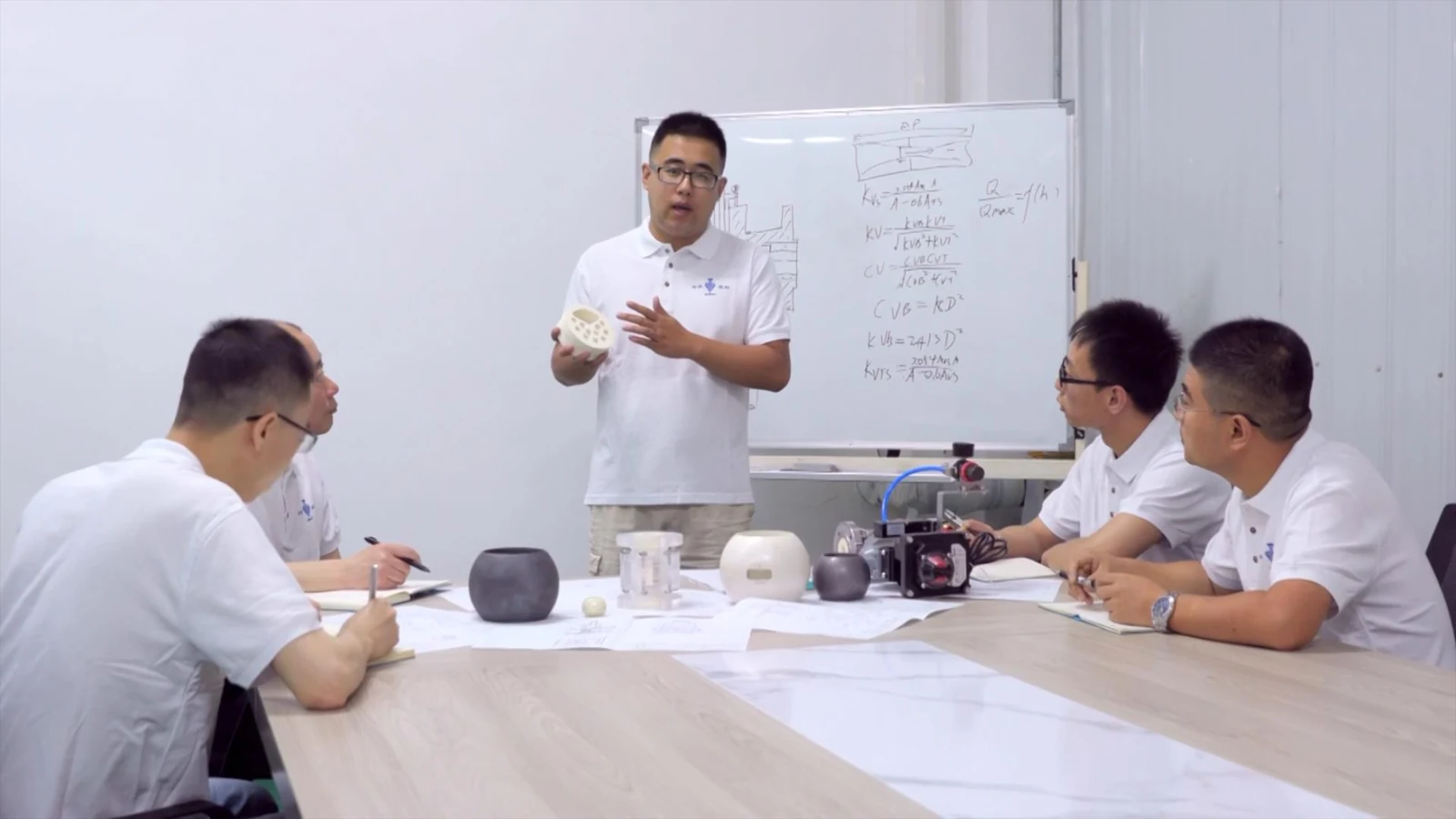 KOWOV engineers reviewing a ceramic valve design